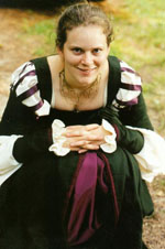 Clair crouching in a Renaissance dress